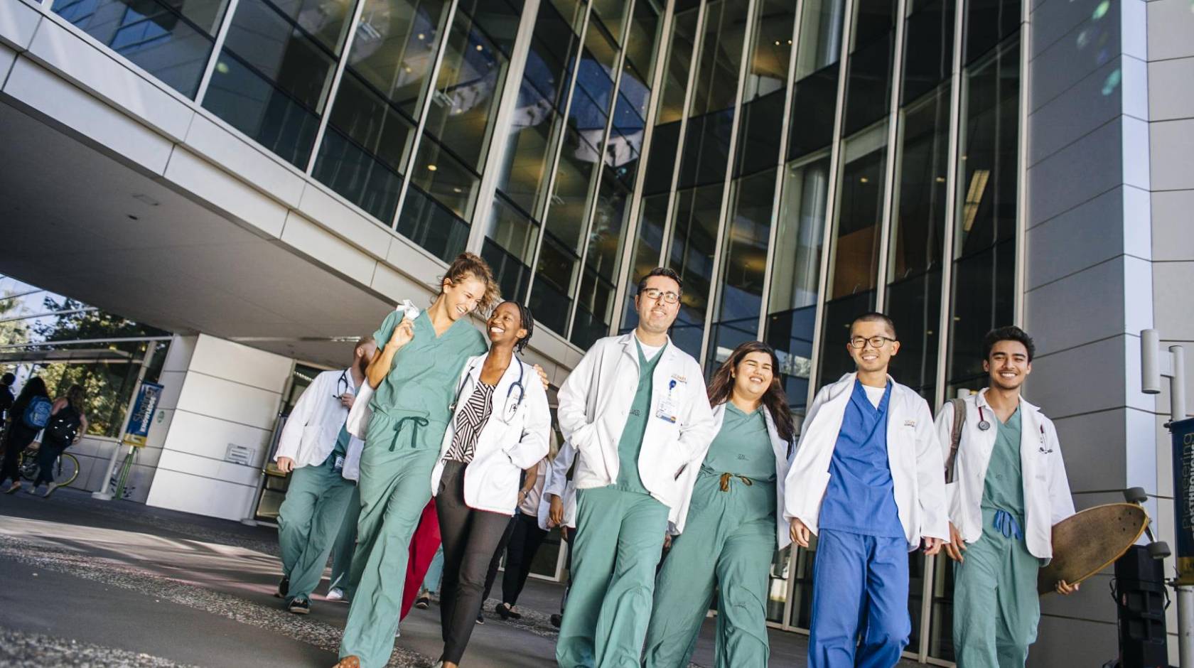 University of California Health students leaving a building together in scrubs