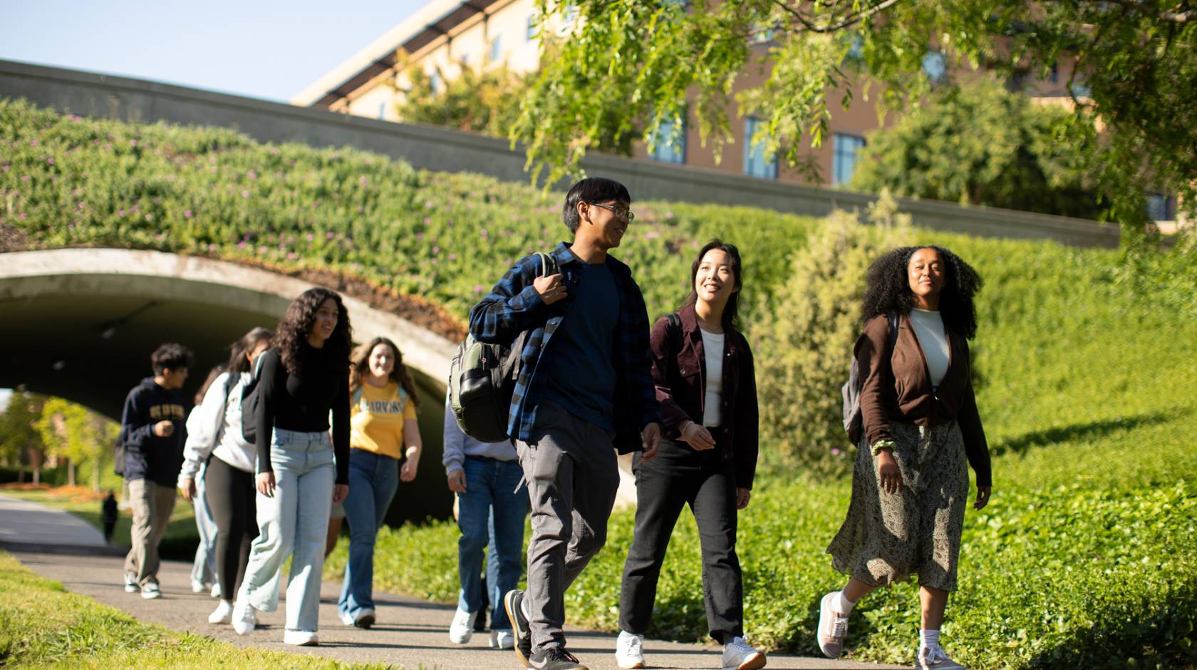 Group of diverse students walking on UC Irvine campus