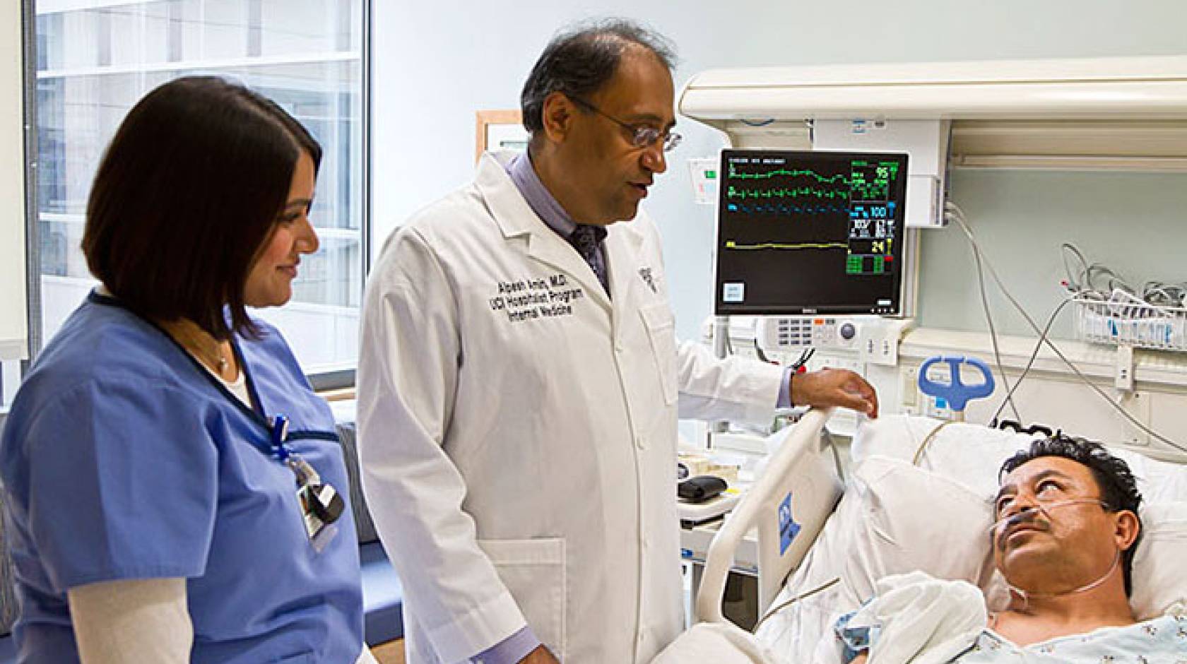 Dr. Alpesh Amin (center) with medical staffer and patient