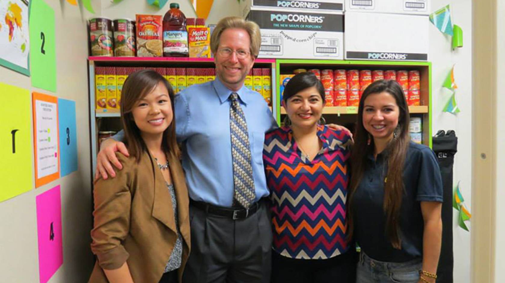 Standing inside the food pantry at UCI's Student Outreach & Retention Center are (from left) ASUCI food security Co-commissioner Erica Wong, Orange County Food Bank Director Mark Lowry, SOAR Director Graciela Fernandez and ASUCI food security Co-commissio