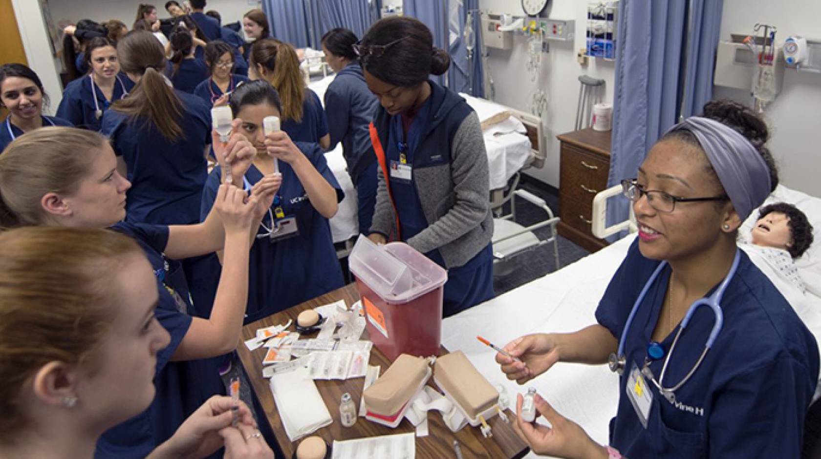 Undergrad nursing students practice injections in Berk Hall at UC Irvine.