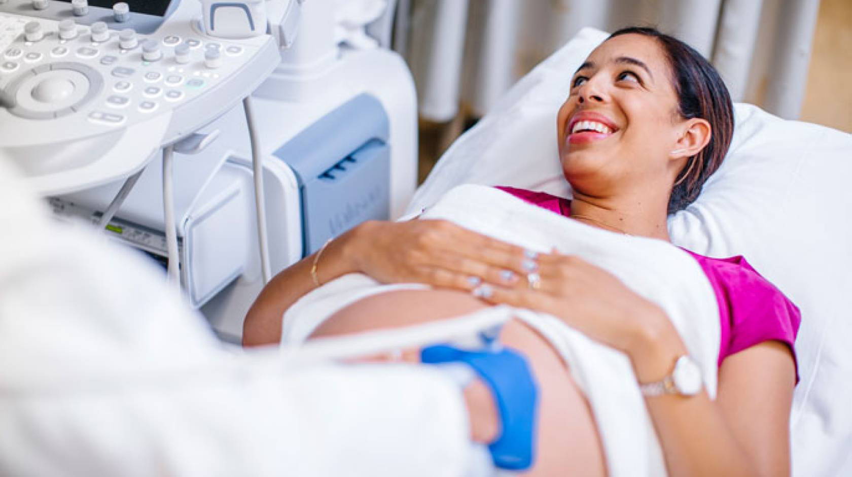 Happy pregnant woman at UCLA Health being screened