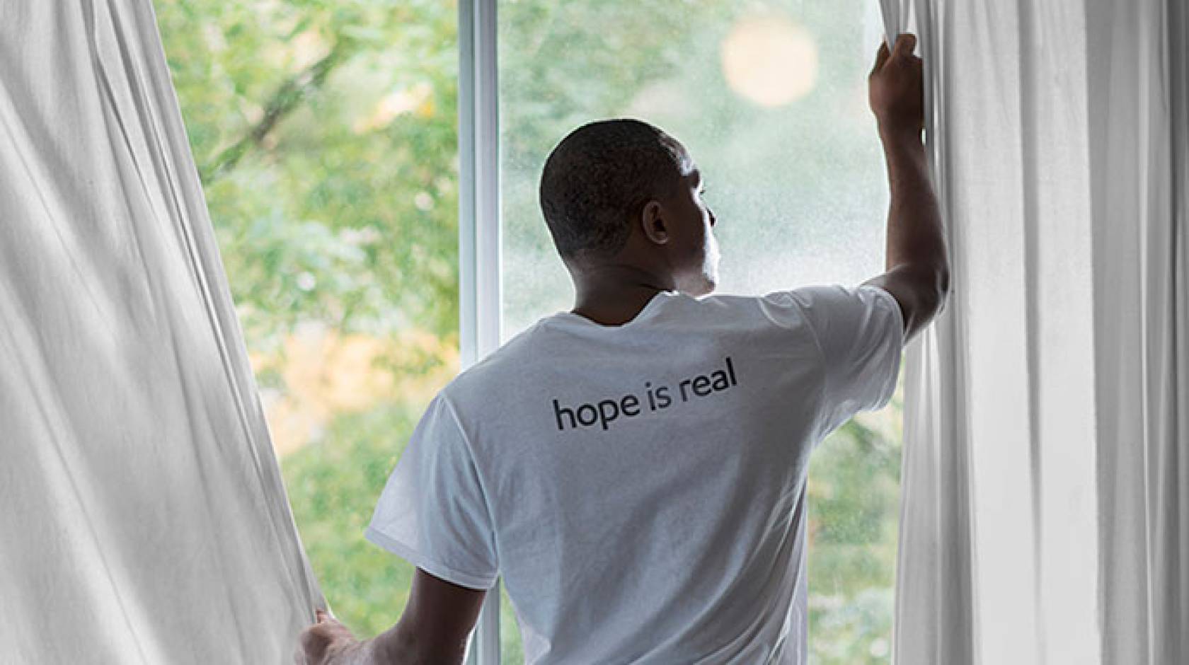 man at window (Getty Images)