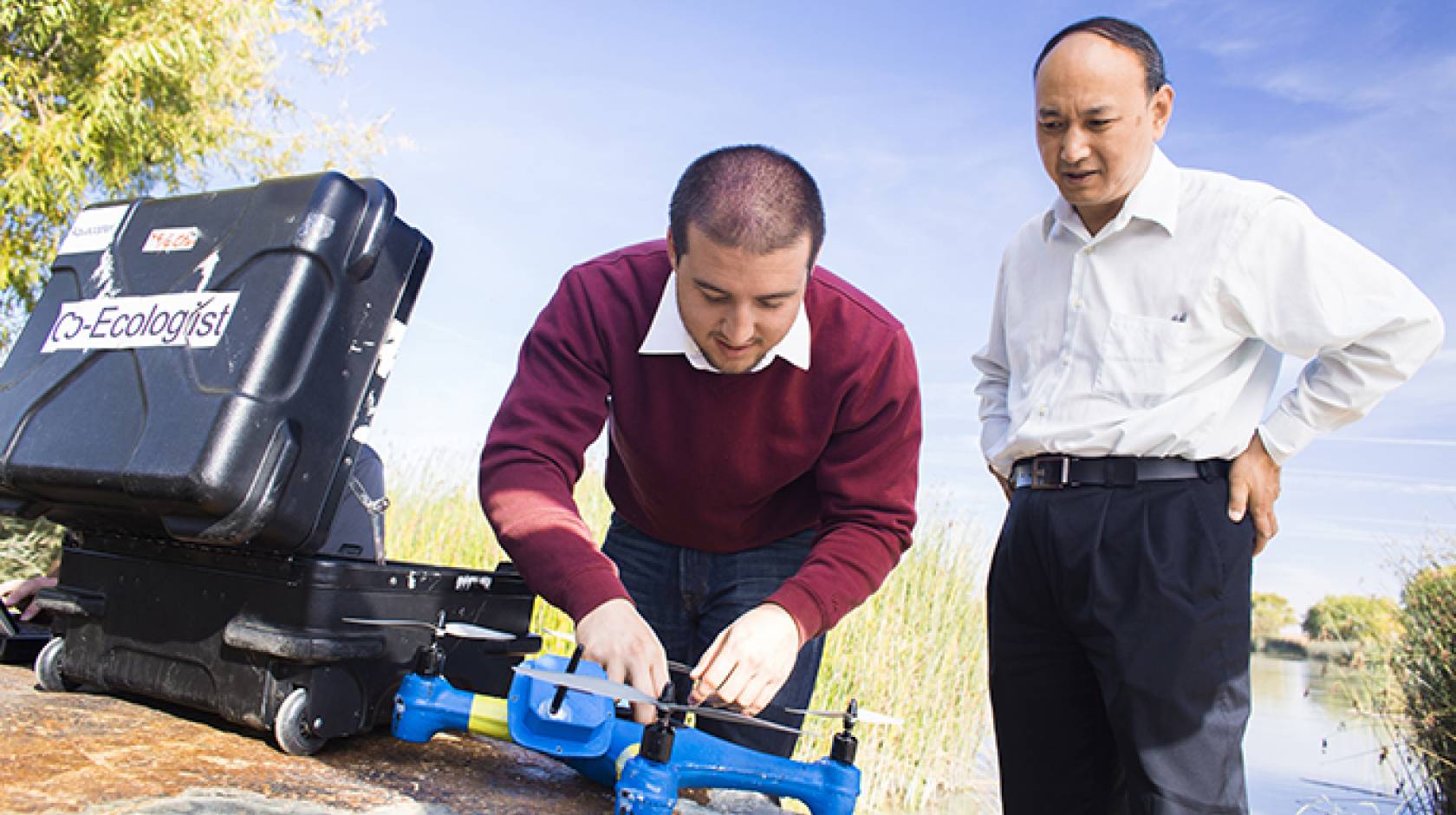 UC Merced professor YangQuan Chen (right) and student Brendan Smith work with drones.