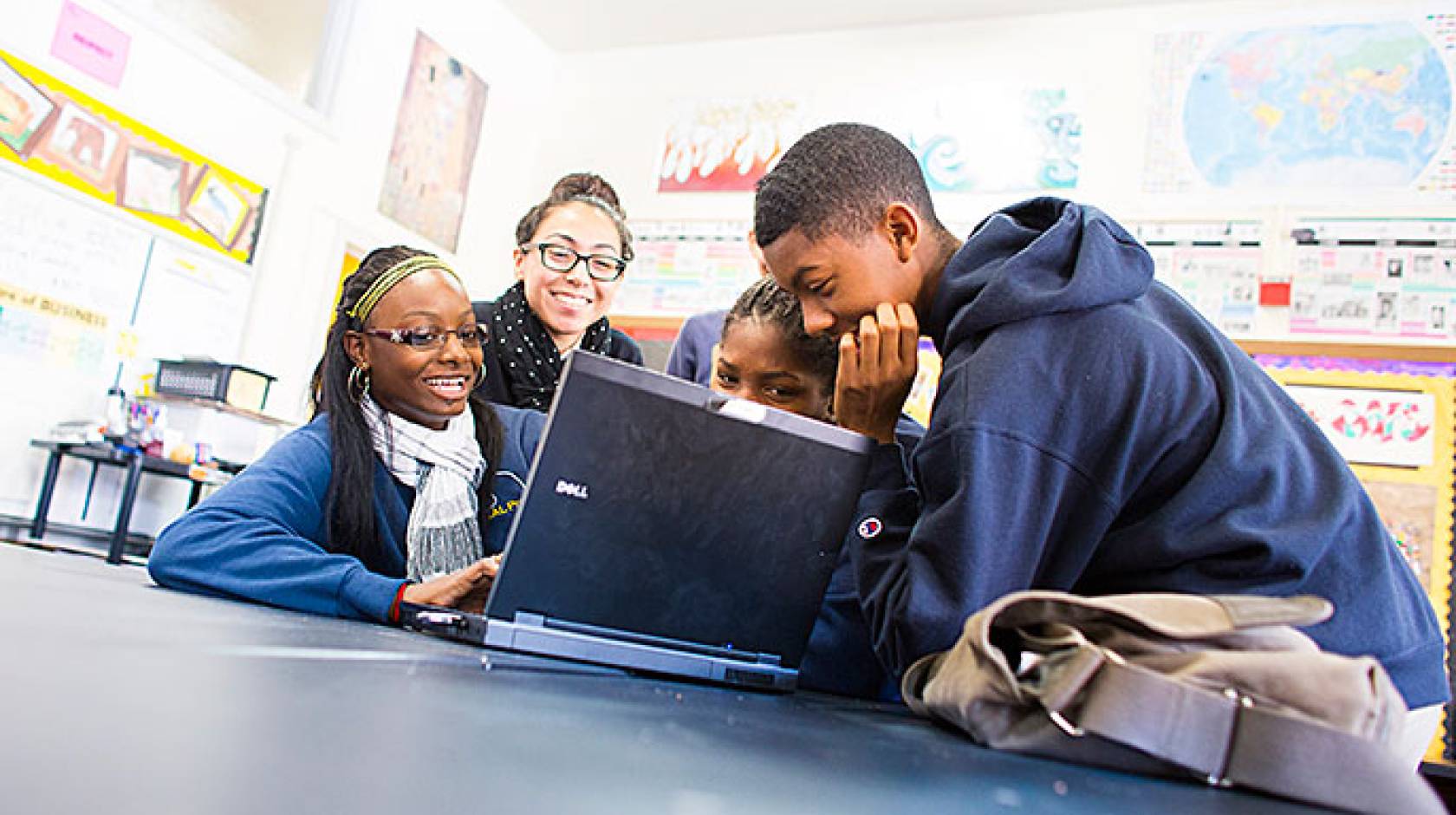 students around laptop