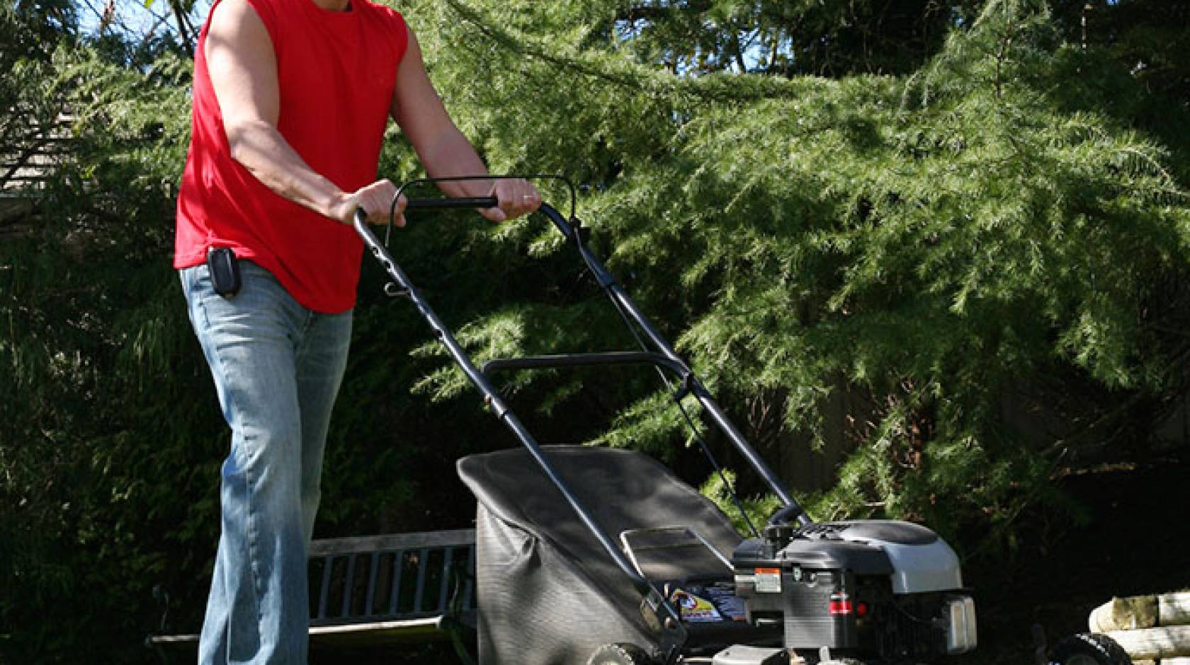 man using lawnmower