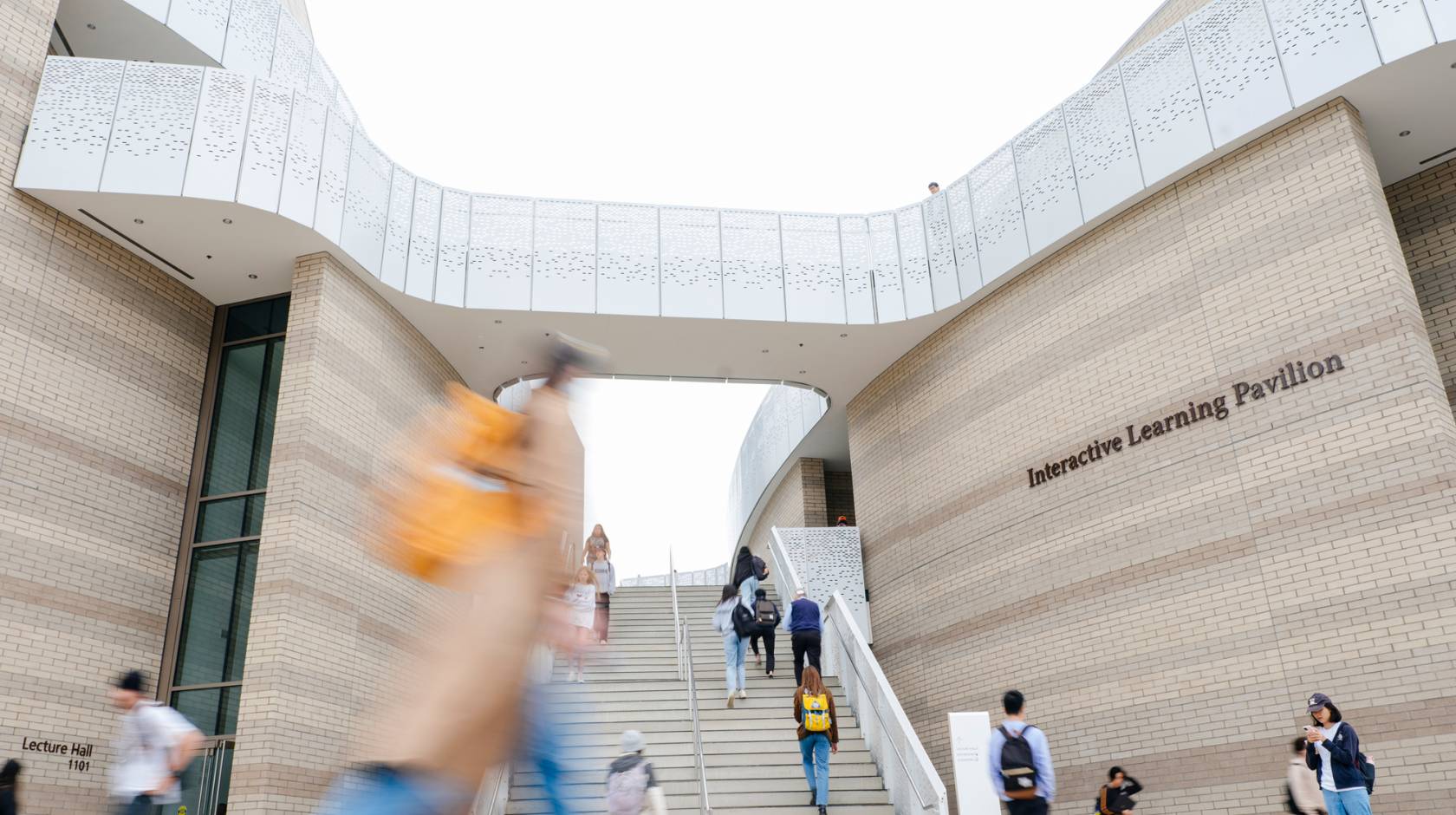 Students walk on the UC Santa Barbara campus in front of the Interactive Learning Pavilion