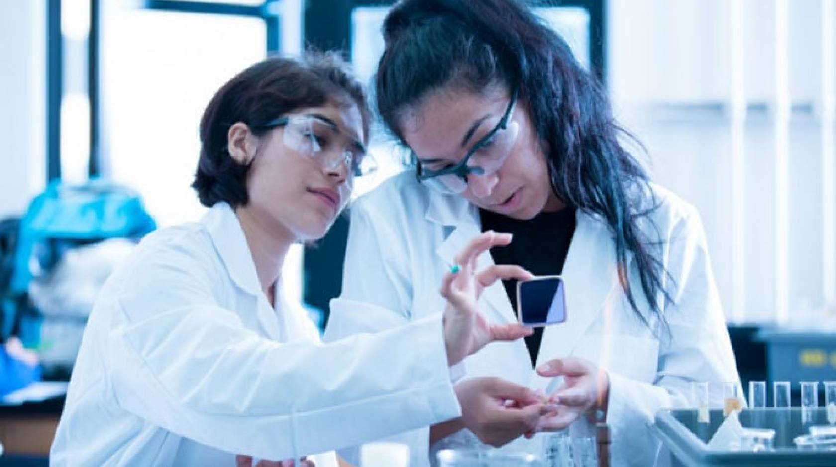 Two students of color working in a lab