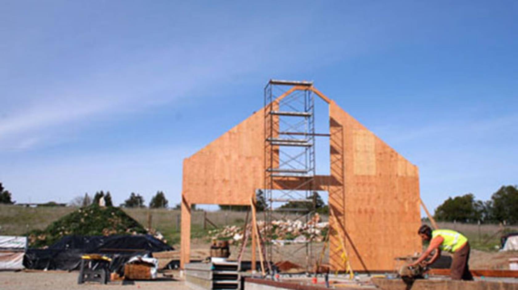 A craftsman from Santa Cruz Timberframes works on an original timber slated to become part of the re-creation of the Cowell Ranch Hay Barn.