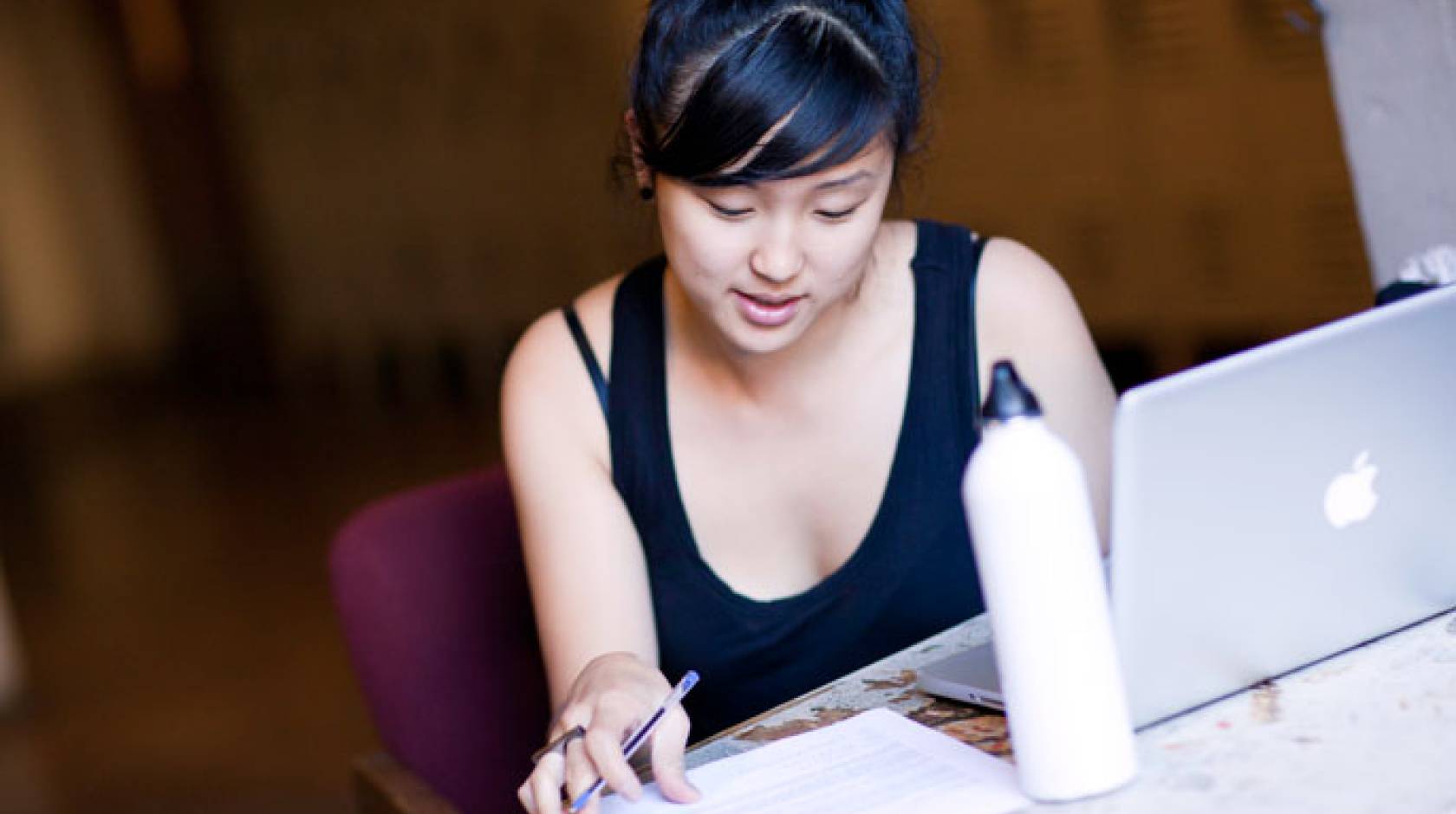 Young woman studies at computer