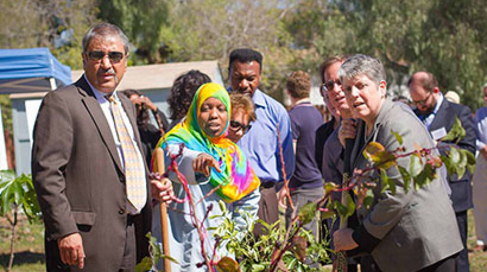 University of California President Janet Napolitano and UC San Diego Chancellor Pradeep K. Khosla listen as volunteer Karemah Alhark talks about the Ocean View Growing Grounds.