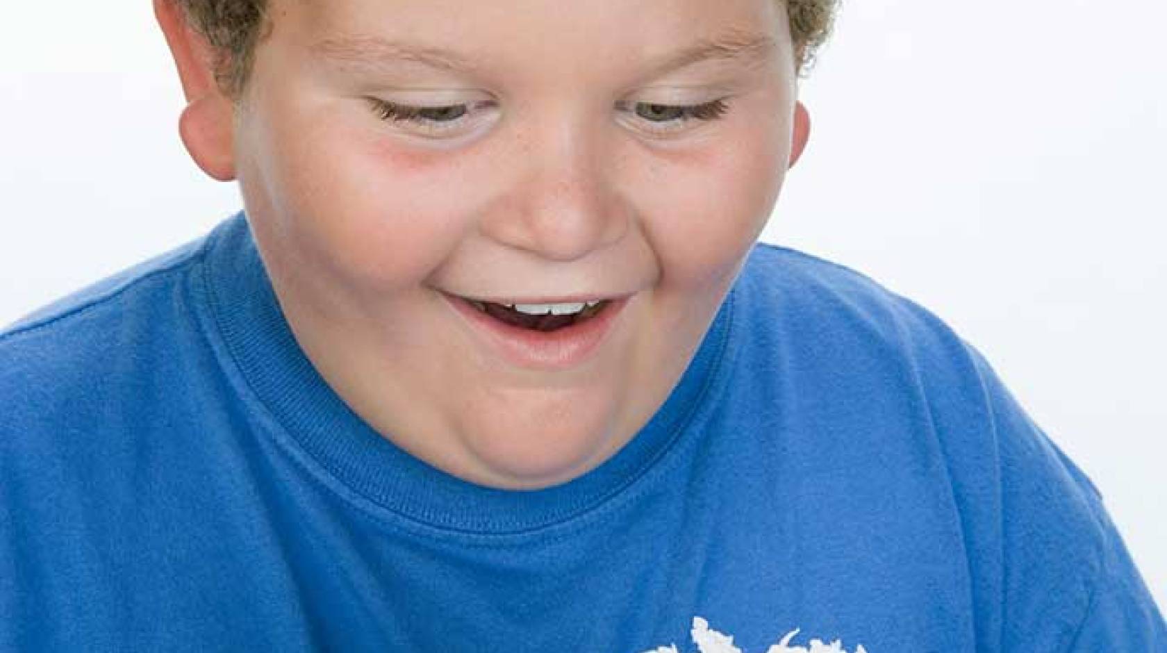 overweight boy with slice of cake (iStock)