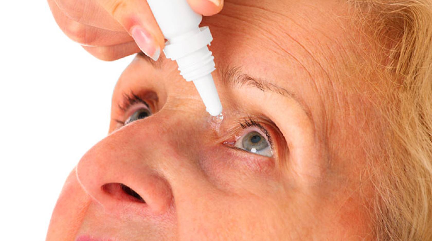 woman administering eye drops