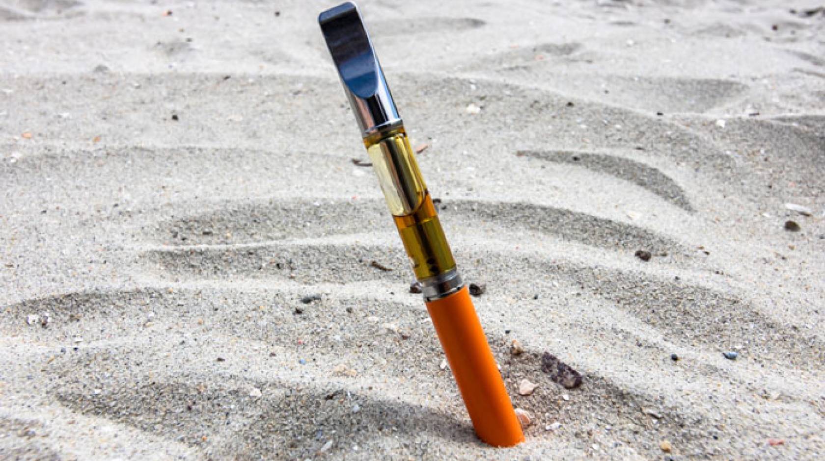 Vape pen stuck in sand