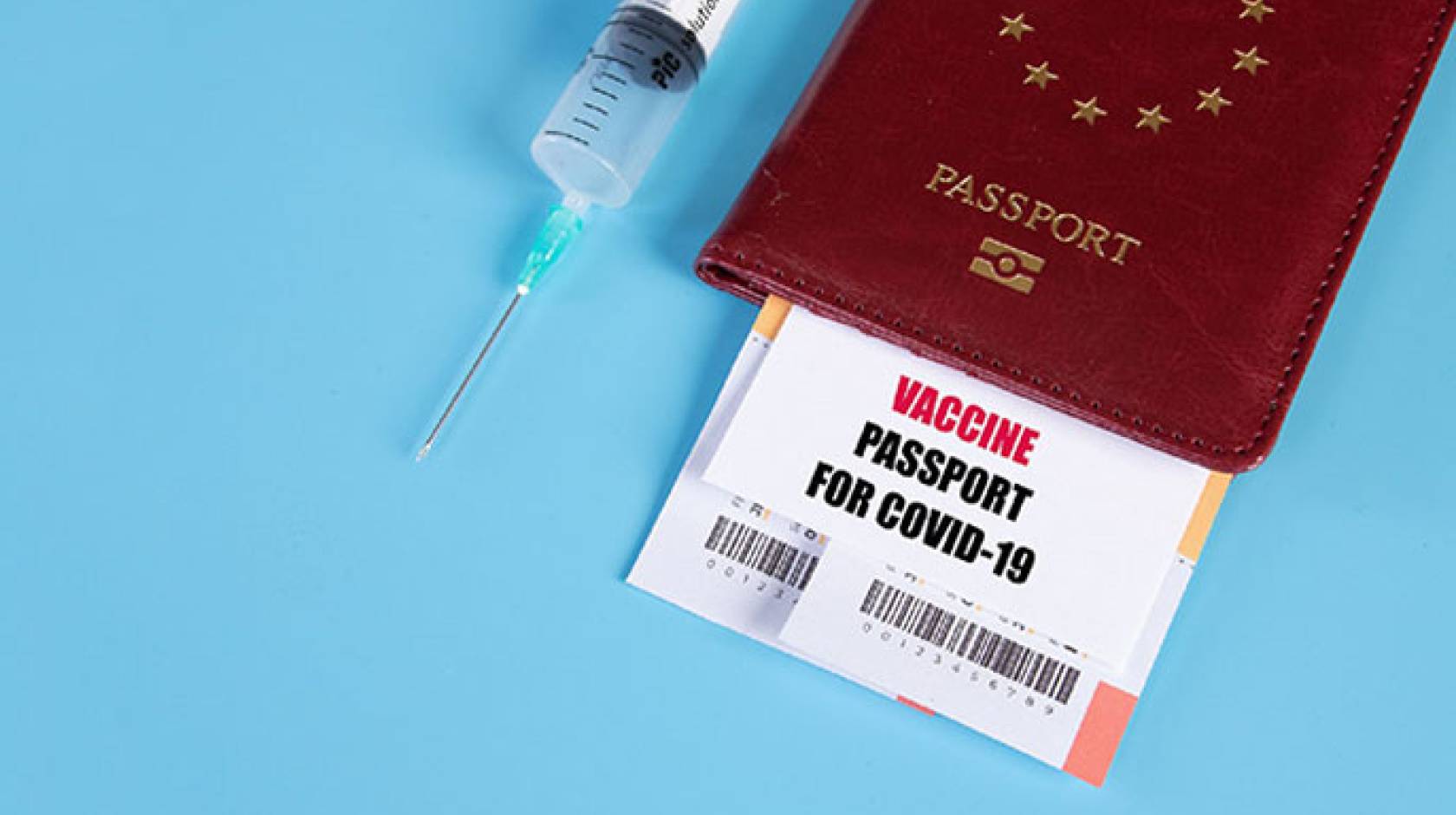 Passport next to a syringe