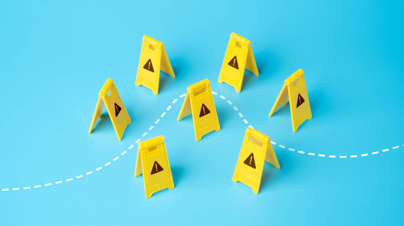 A set of childlike yellow construction warning signs with little warning signs on them with a dotted line going through, on a light blue background