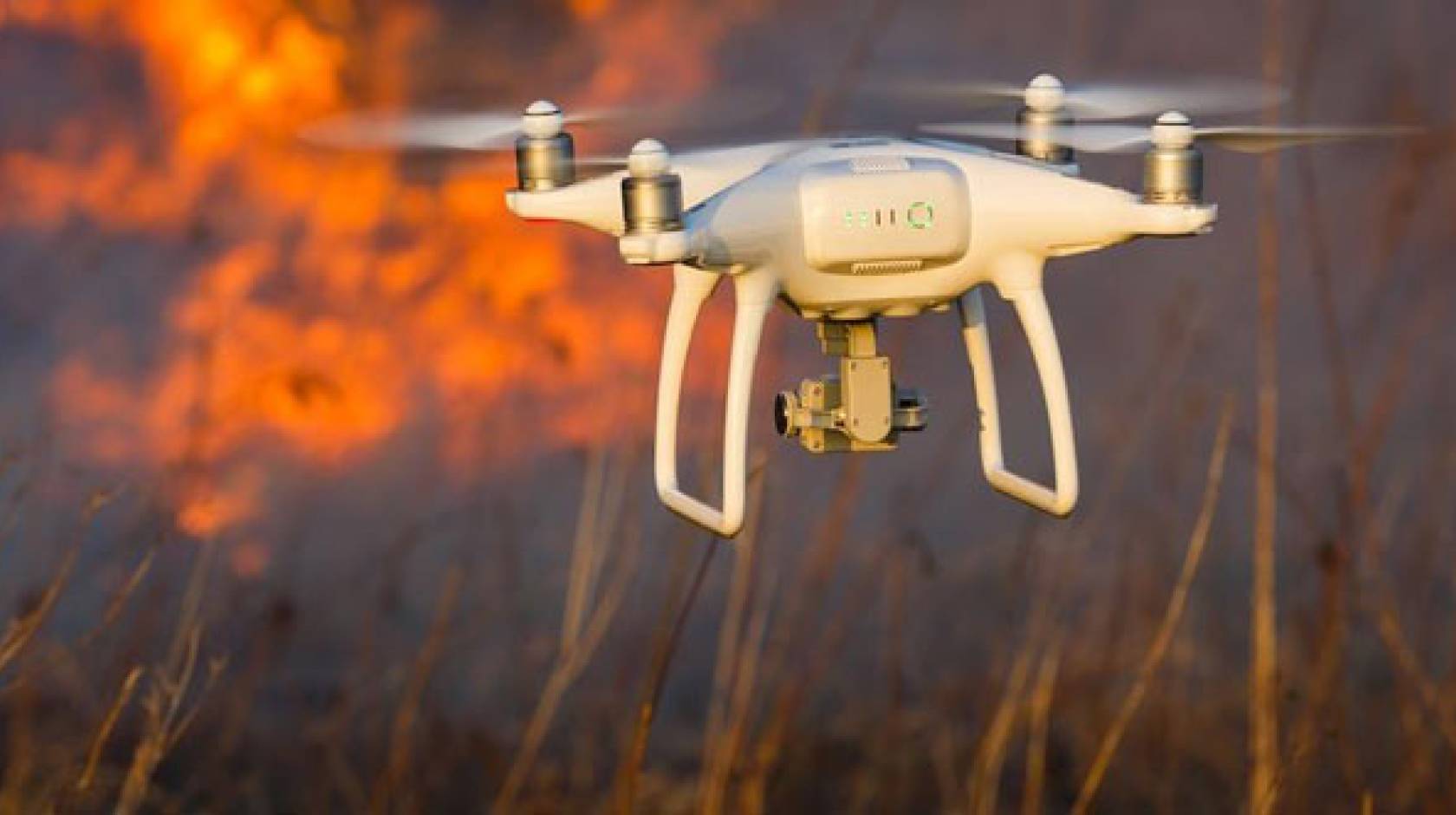 A drone with wildfire in the background