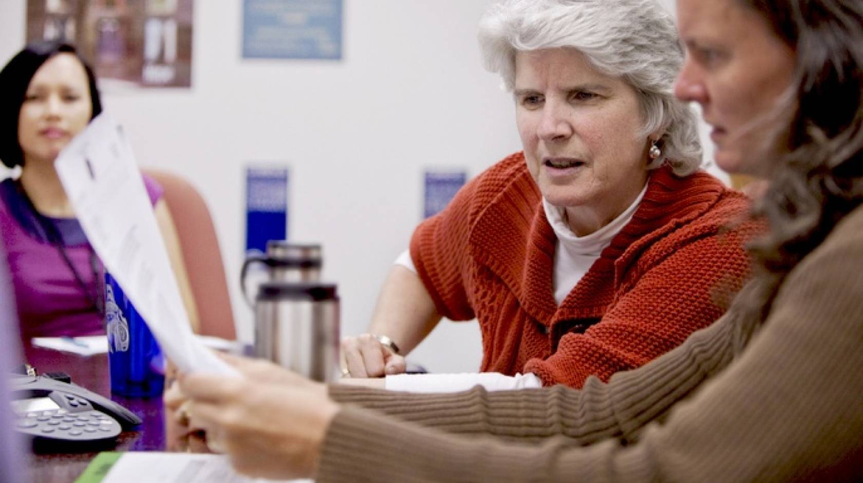 staff discussing a document