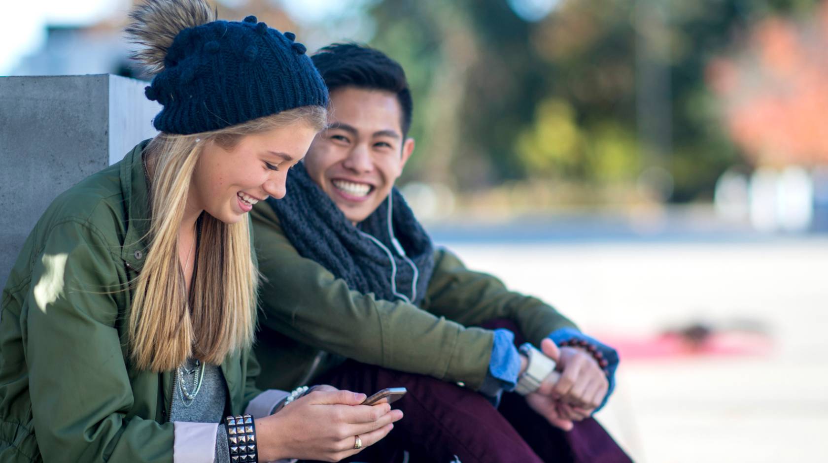 Young man smiling at a young woman