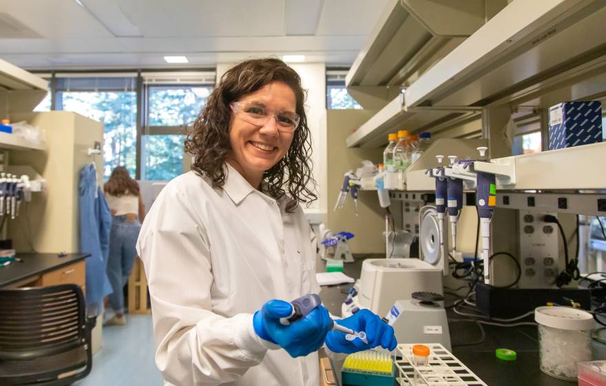 Karen Miga in the lab, smiling