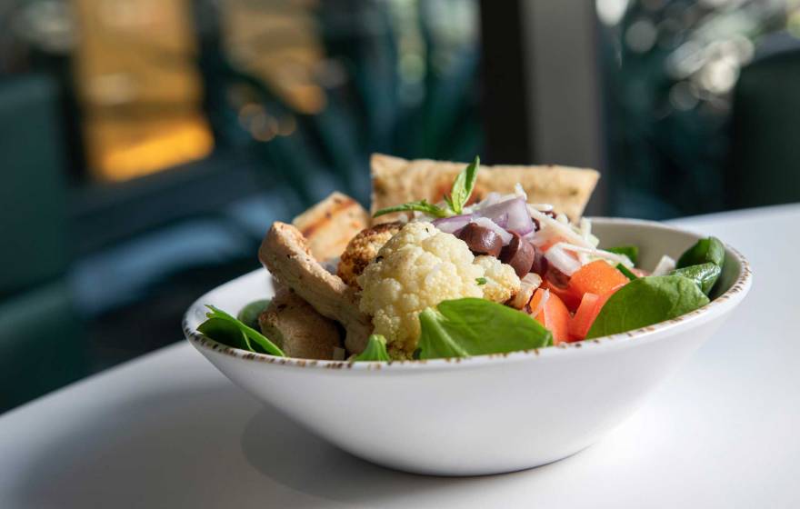 A bowl of cauliflower, spinach, tofu and other plant-based foods