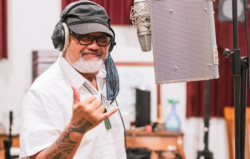 Bruddah Waltah flashes a shaka in a recording studio