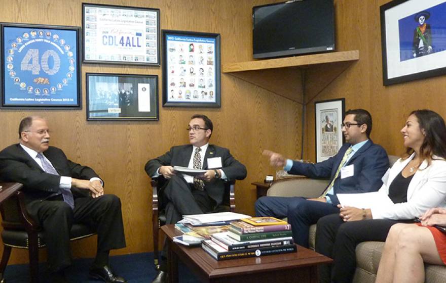 UC Riverside grad students Vicente Nunez and Jessica Diaz, along with graduate dean Joseph Childers, chatted with state Assemblyman Jose Medina about the nature of their research.