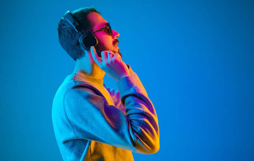 Young man listening to music with headphones on.