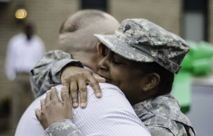 A member of the Georgia National Guard being hugged