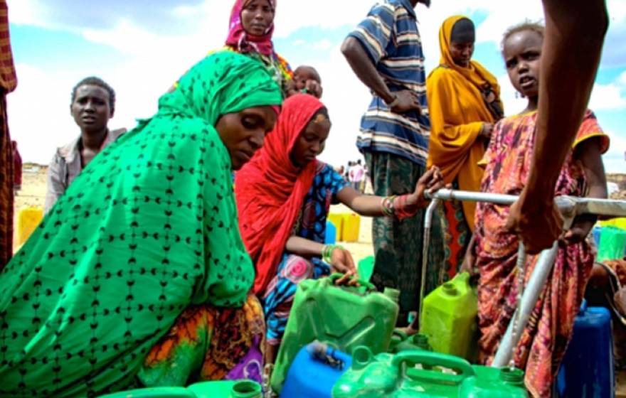 In the aftermath of an intense El Nino-induced drought, people gather around an Oxfam provided water tank in Hariso, Ethiopia.