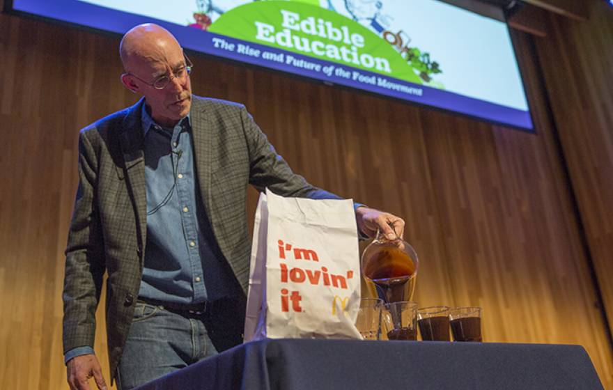 Michael Pollan makes a point about the amount of oil it takes to produce a hamburger during an Edible Education lecture at UC Berkeley.