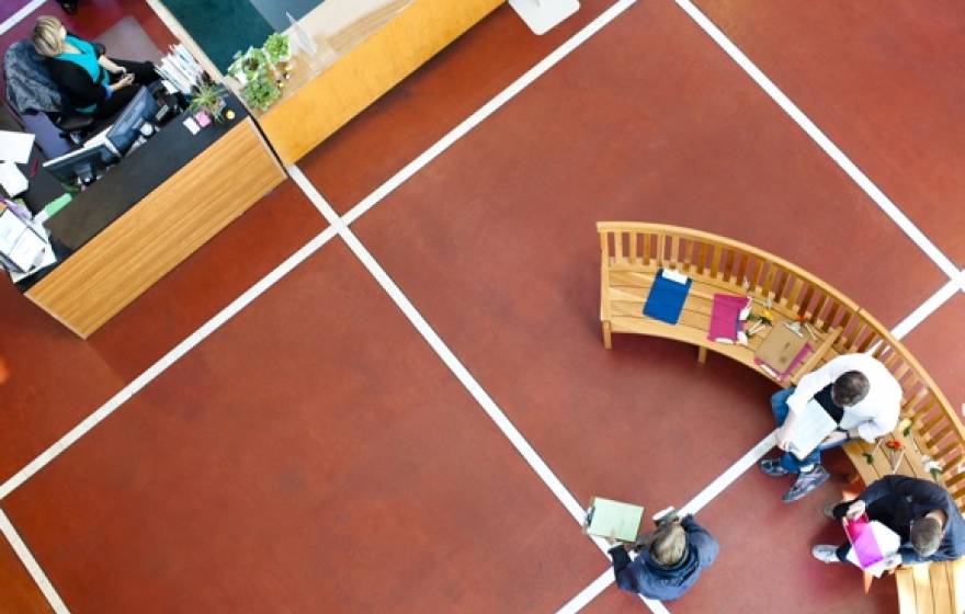 students in an atrium with clipboards