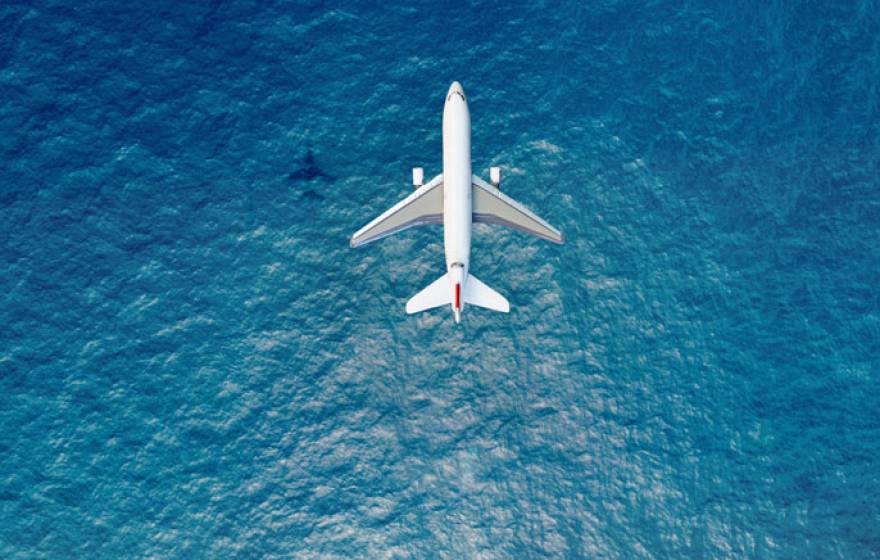 Airplane flying over the sea