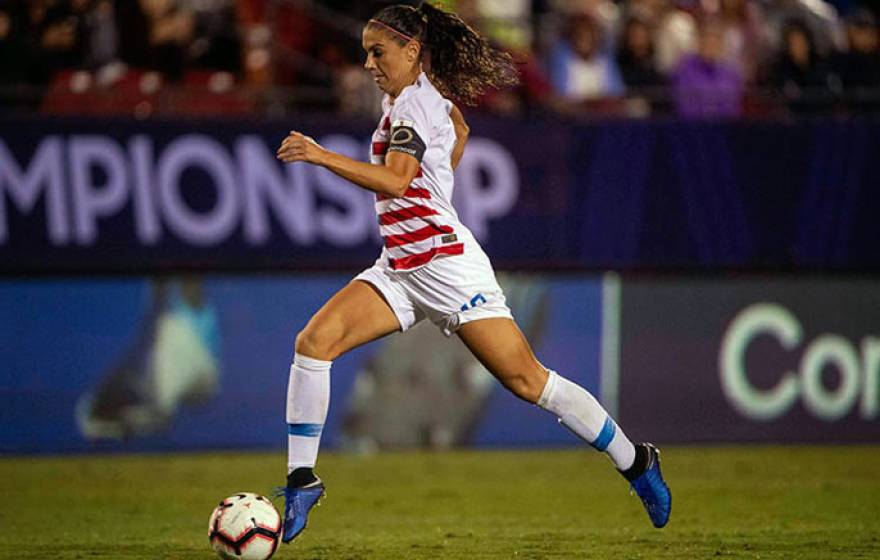 Alex Morgan dribbles during a game