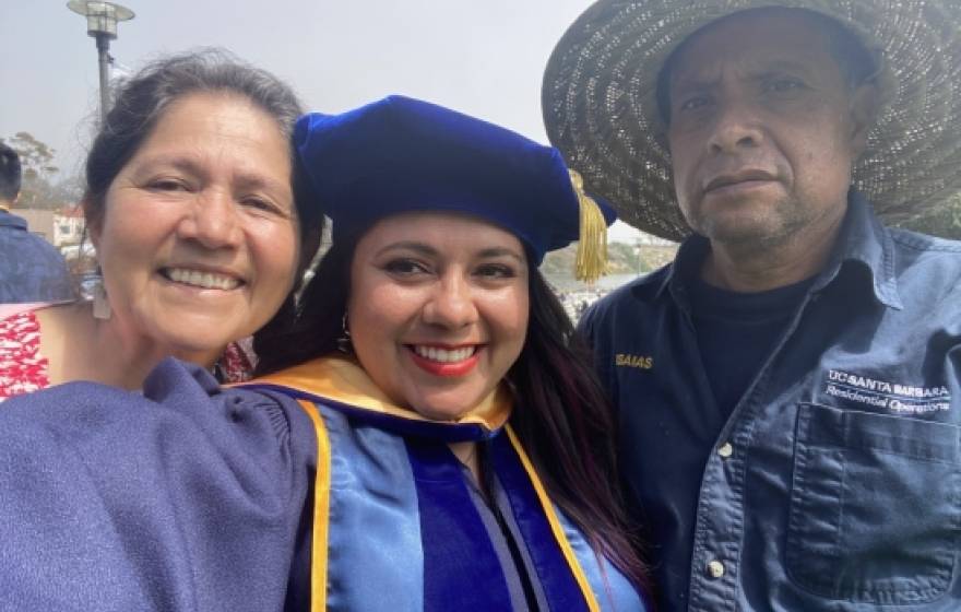 Dr. Ana Y. Guerrero in cap and gown with her parents, a selfie