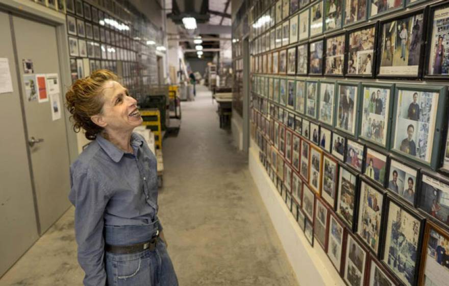 Annabeth Rosen looks at a wall of pictures