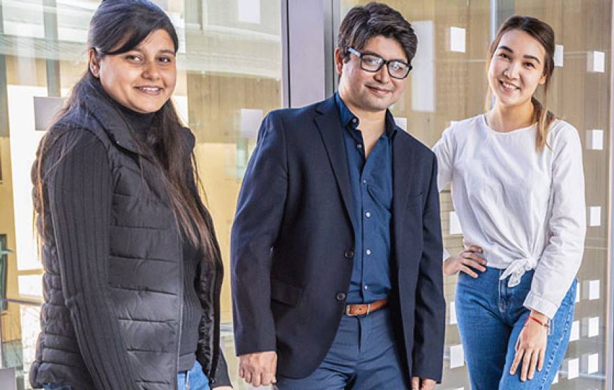 Professor Arif, center, with graduate students Laxmi Pandey, left, and Gulnar Rakhmetulla