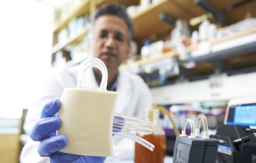 A researcher holding a piece of medical equipment