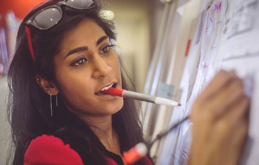 Woman writing on a board