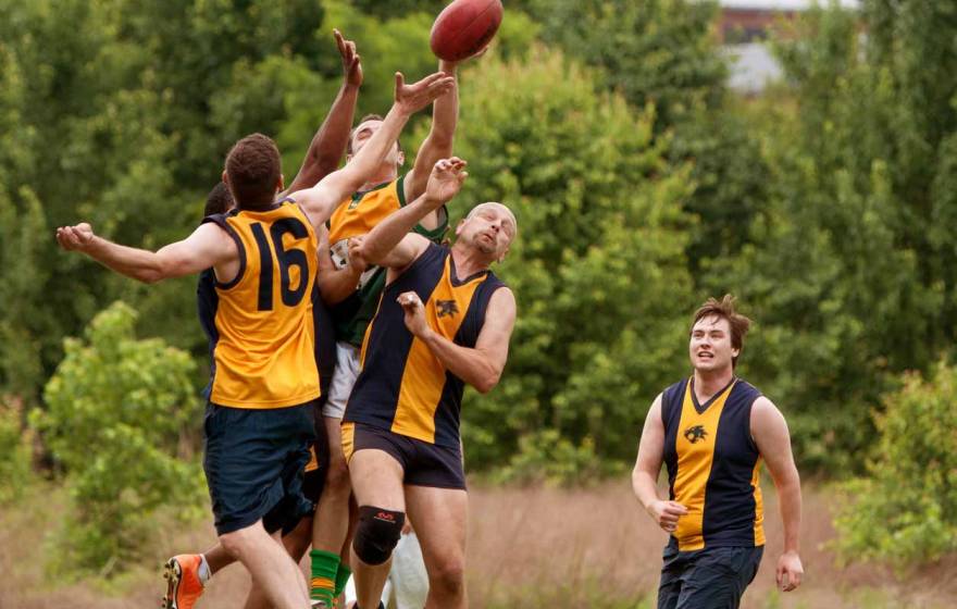 Australian football players collide over ball