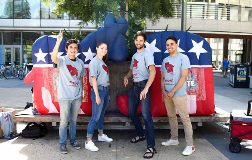 Students in front of the Democrat and Republican mascots in papier-mâché