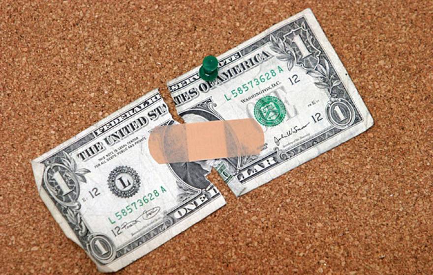 bandaged dollar (Shutterstock)