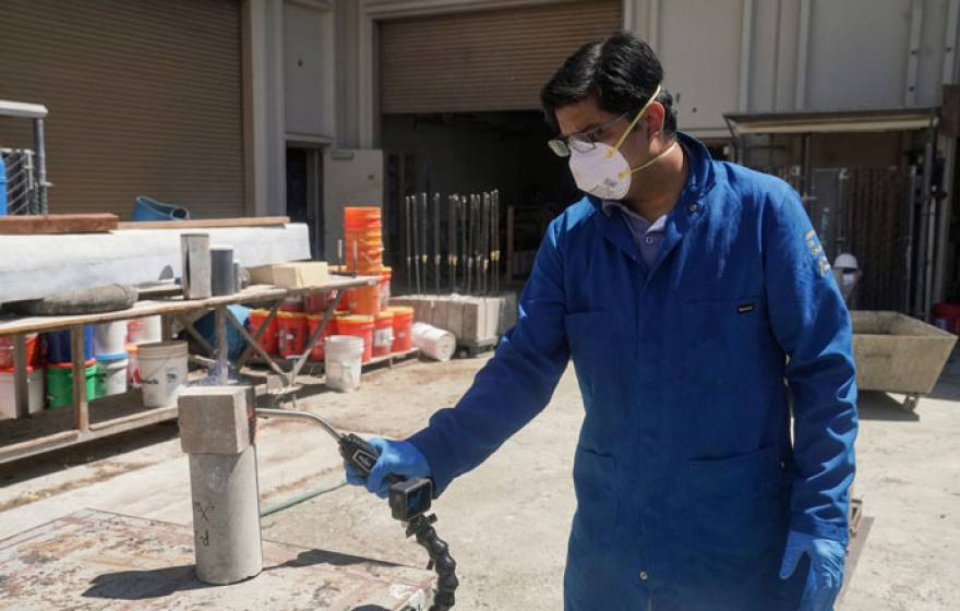 Researcher using a blow torch on a block