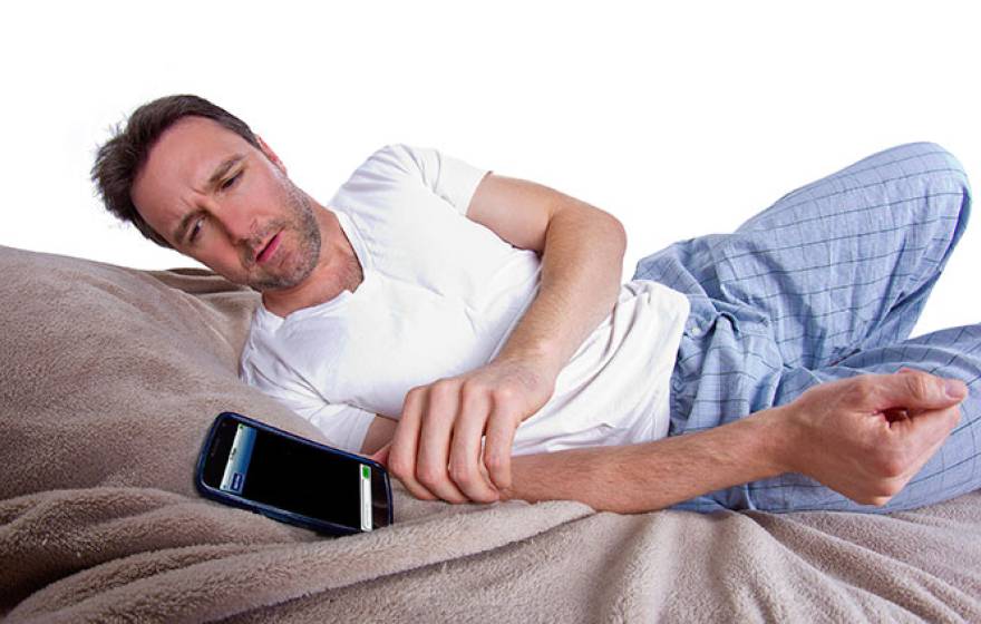 man in bed with cell phone