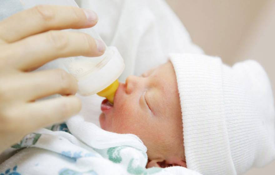 an infant feeding from formula