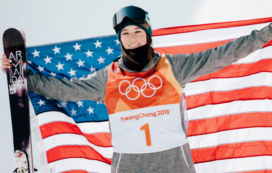 Brita Sigourney holds the U.S. flag after a medal-winning run in 2018