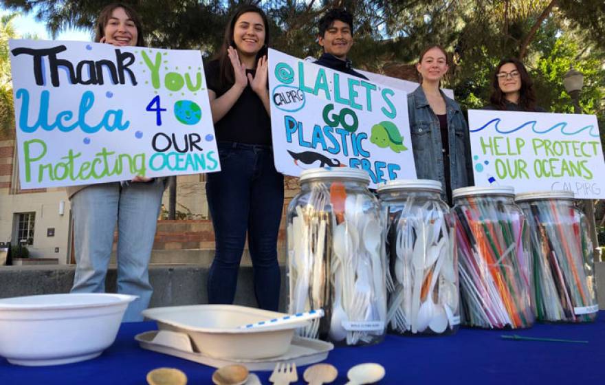 Students from CALPIRG hold up signs thanking UCLA and saying help protect our oceans