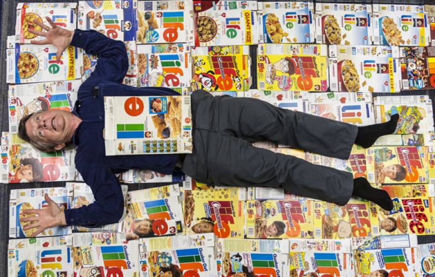 Professor lying on top of cereal boxes