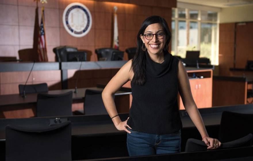 Viridiana Chabolla stands in a courtroom, smiles