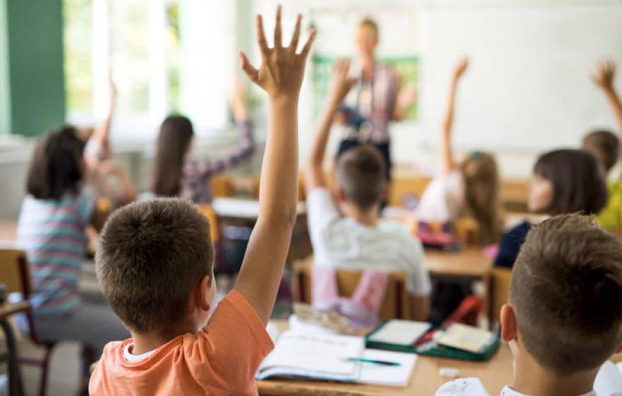 Children raising their hands